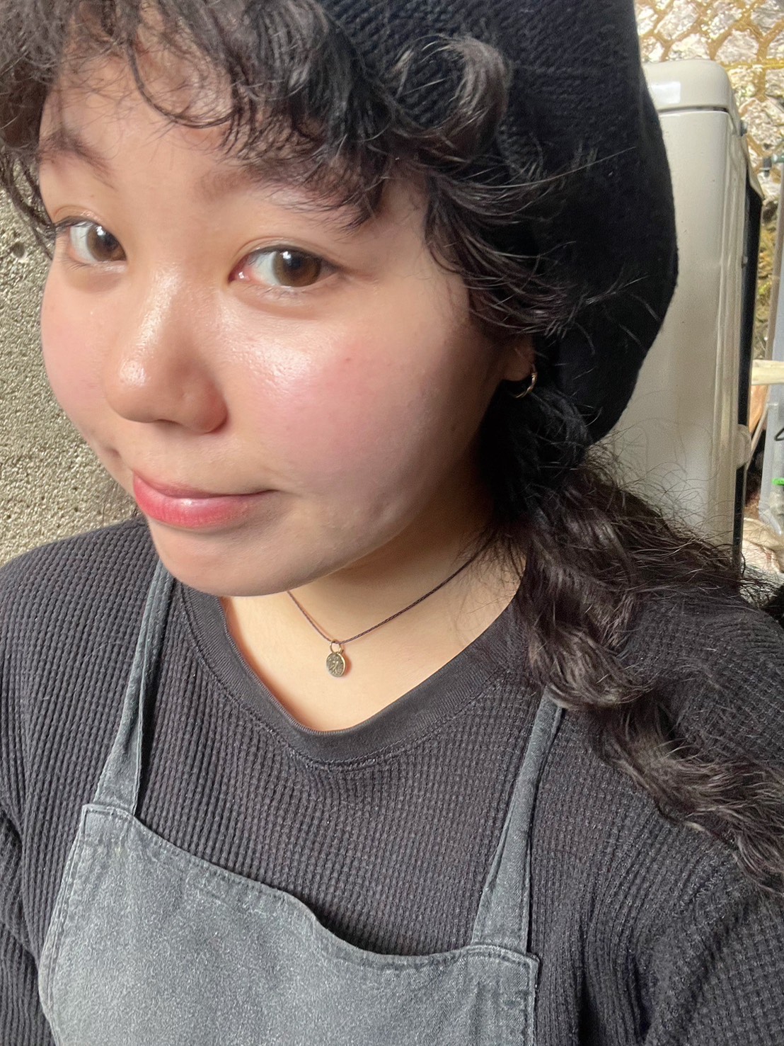 Anju smiling with a coffee
